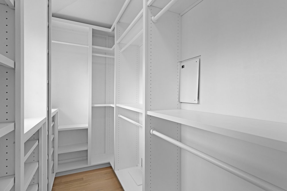 1609 Hartford Road, Unit A Austin, TX 78703 - Photo 30 of 39 A customized closet system featuring multiple shelves and hanging rods offers organized storage.