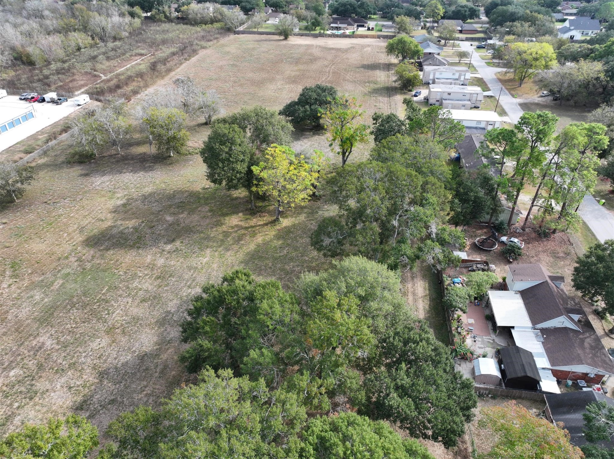 2417 4th Street Rosenberg, TX 77471 - Photo 14 of 50 an aerial view of residential houses with outdoor space and trees