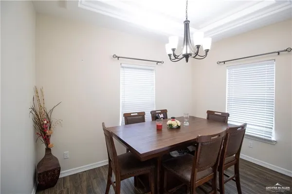 a view of a dining room with a table and chairs