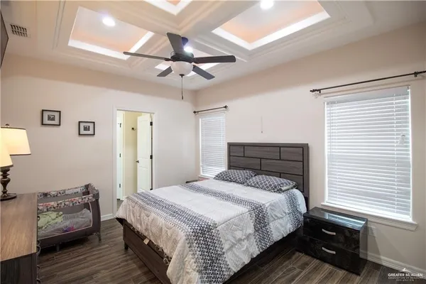 a bedroom with a bed and a chandelier