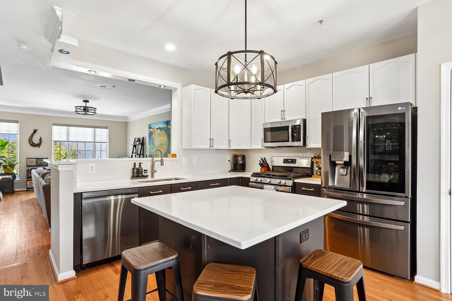 2530 Carrington Way Frederick, MD 21702 - Photo 3 of 38 a kitchen with a center island and stainless steel appliances