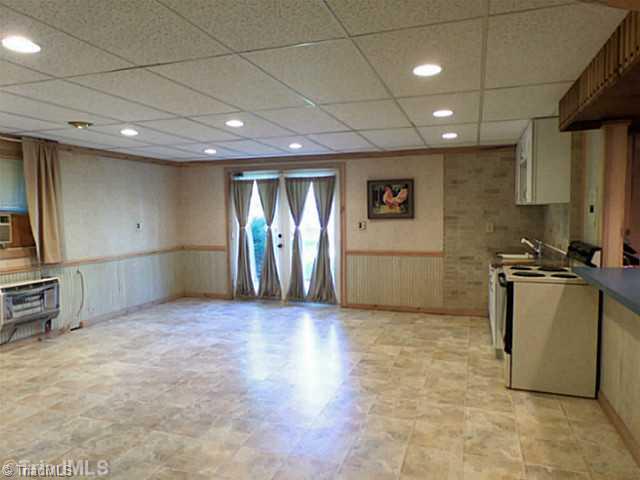 3161 Alamance Church Road Julian, NC 27283 - Photo 13 of 16 Other. In-Law walk out basement apartment with kitchen, full bath, bedroom, spacious living area, storage, & stone fireplace.