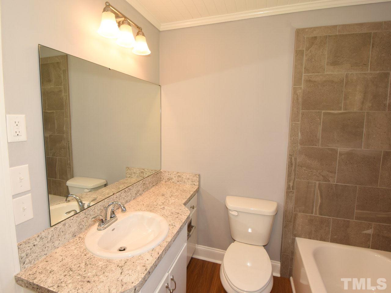 1525 Micro Road Selma, NC 27576 - Photo 16 of 25 Updated vanity, tub/shower/tile,, new flooring, fresh paint, new lighting fixtures.