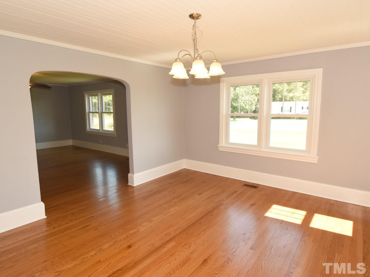 1525 Micro Road Selma, NC 27576 - Photo 22 of 25 Beautiful opening from livingroom to diningroom. Beautiful original hardwood floors, wide baseboards, new lighting fixtures, fresh paint