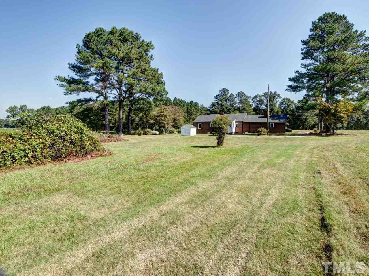 1525 Micro Road Selma, NC 27576 - Photo 25 of 25 Exterior view from packhouse , garden area, grapevine, country heaven