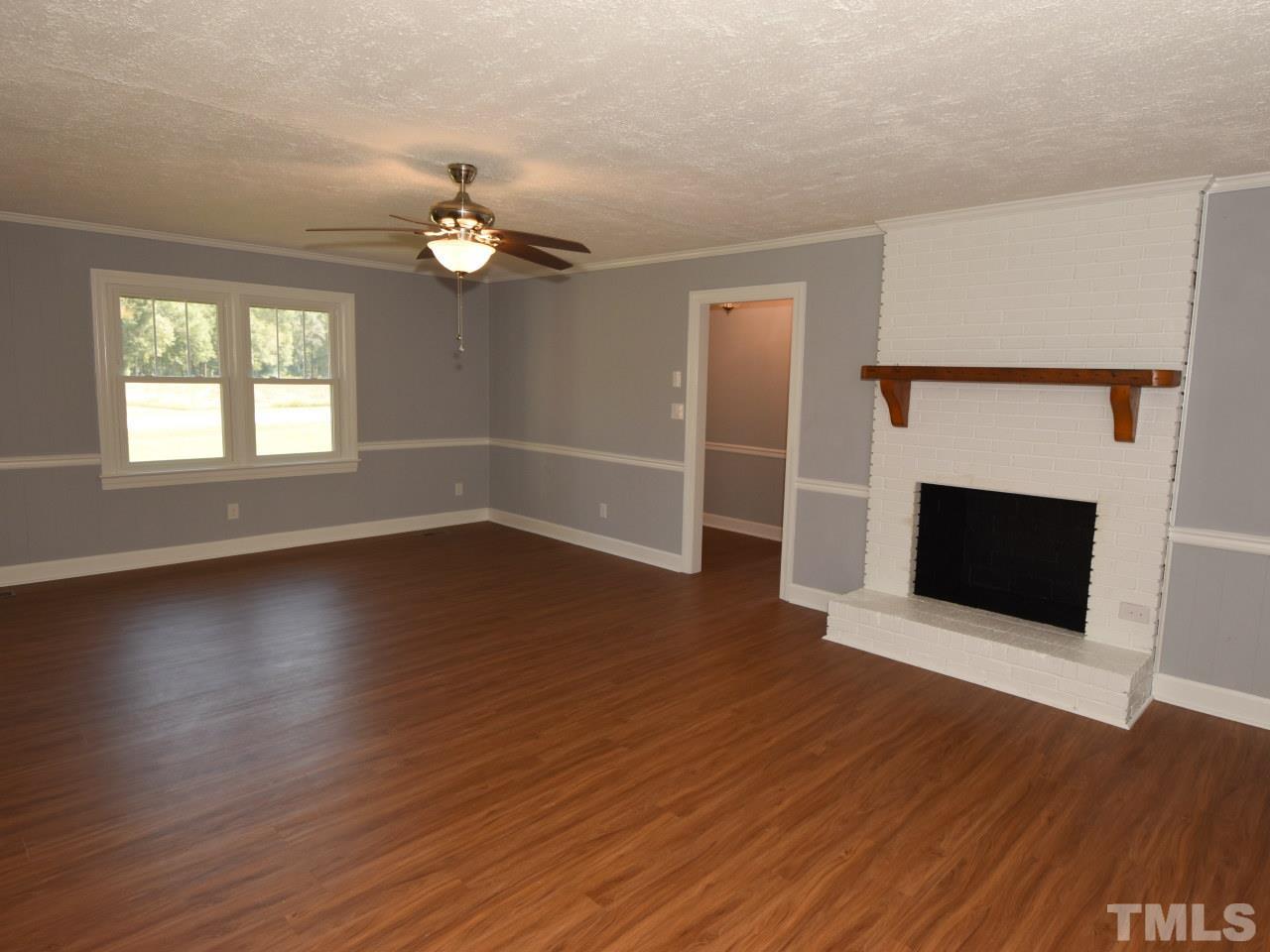 Huge family room with masonry fireplace, fresh paint, Perfect for family gatherings.