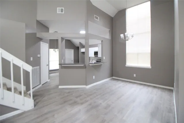 a view of kitchen and hallway with wooden floor