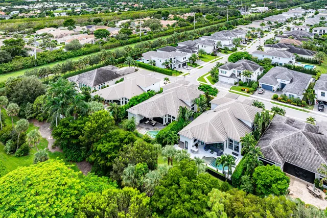 an aerial view of a house with garden space and street view