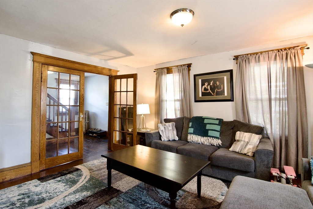 16 Amity Court Springfield, MA 01108 - Photo 6 of 42 a living room with furniture and a floor to ceiling window