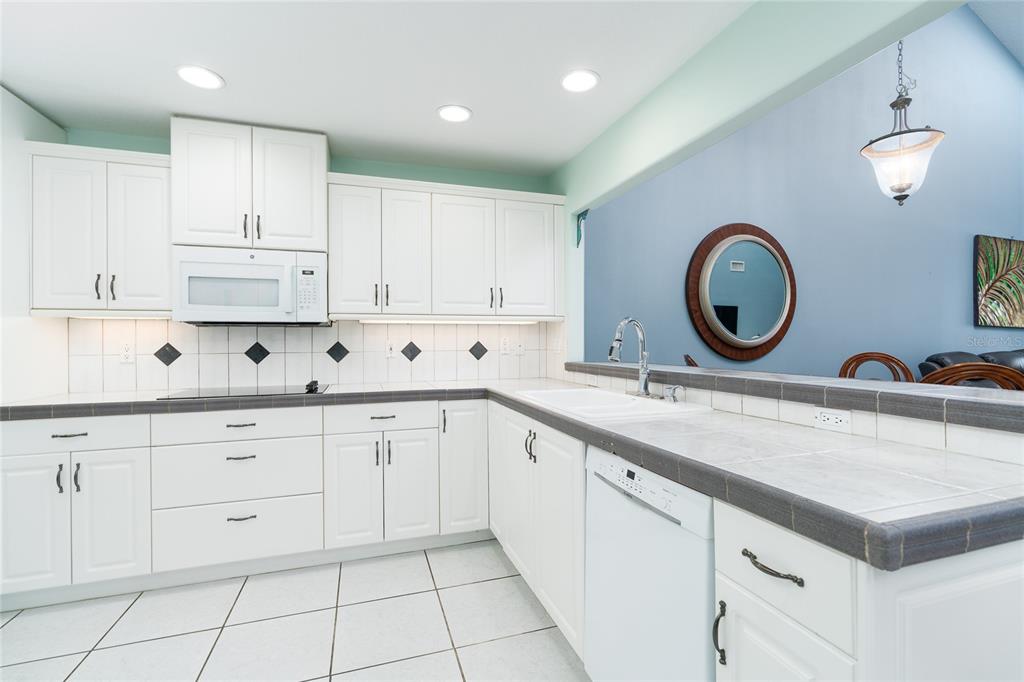 1985 Rutgers Place, Unit 1985 Port Orange, FL 32128 - Photo 13 of 56 a kitchen with white cabinets and sink
