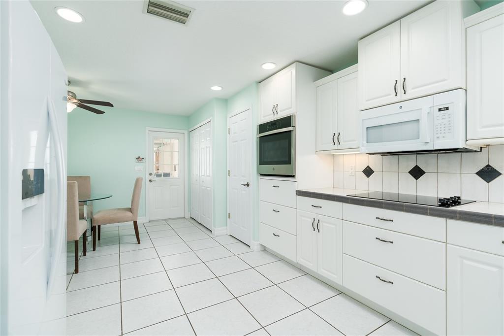 1985 Rutgers Place, Unit 1985 Port Orange, FL 32128 - Photo 14 of 56 a spacious kitchen with white cabinets stainless steel appliances and sink