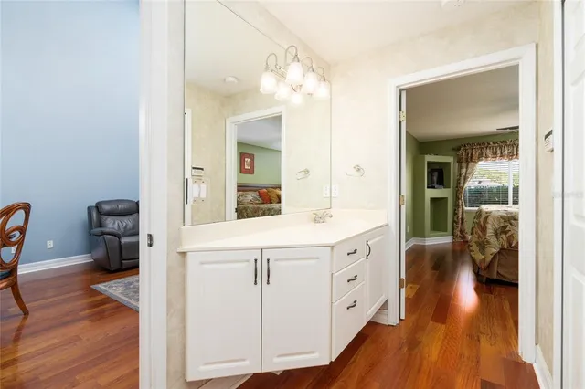 a spacious bathroom with a double vanity sink and a mirror