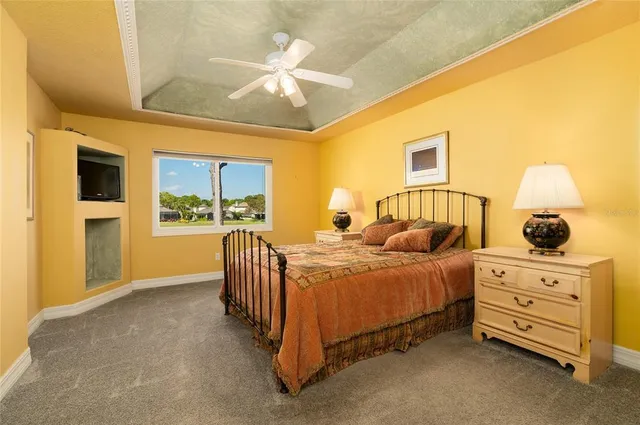 a spacious bedroom with a bed and a chandelier