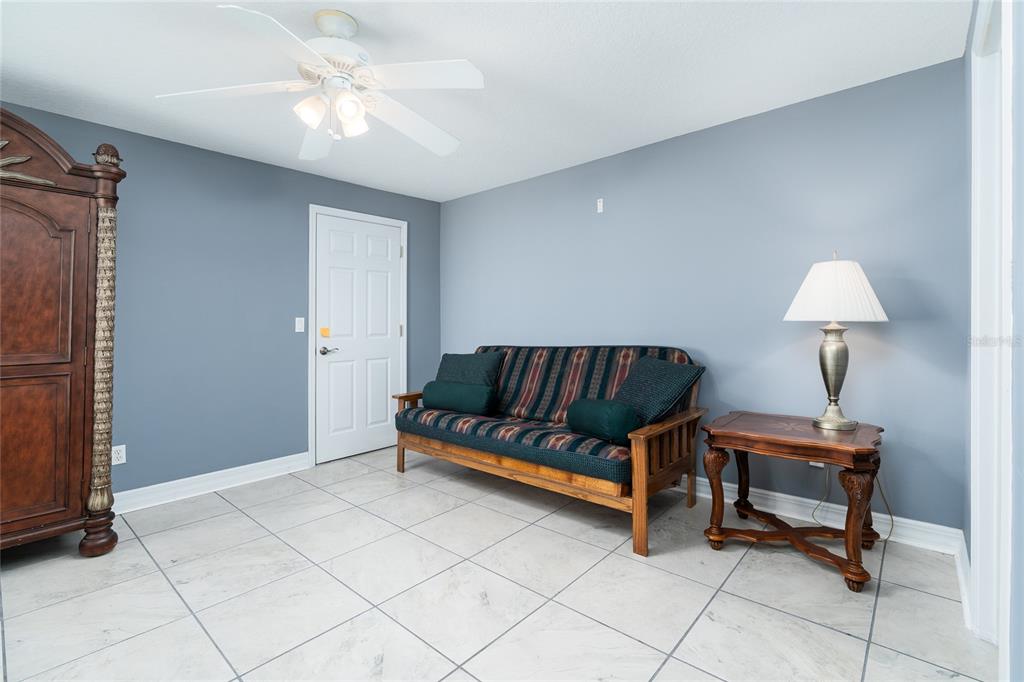 1985 Rutgers Place, Unit 1985 Port Orange, FL 32128 - Photo 26 of 56 a living room with furniture and a lamp