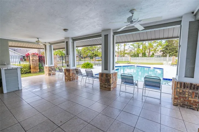 a view of a house with a yard and a fountain