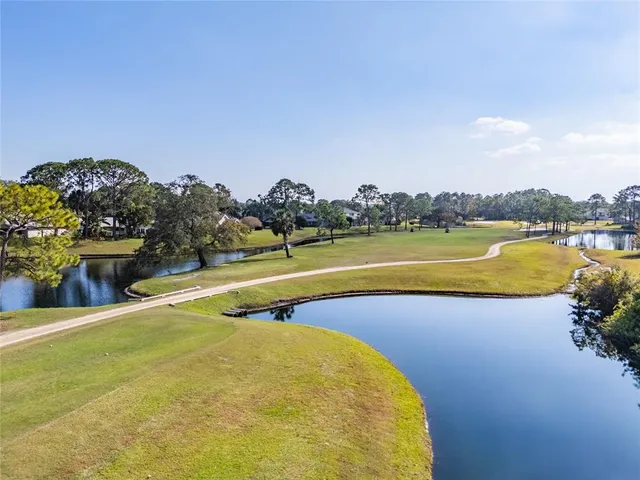 a view of backyard with table and chairs and trees