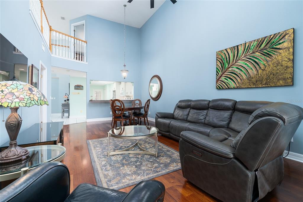 1985 Rutgers Place, Unit 1985 Port Orange, FL 32128 - Photo 5 of 56 a living room with furniture and a chandelier