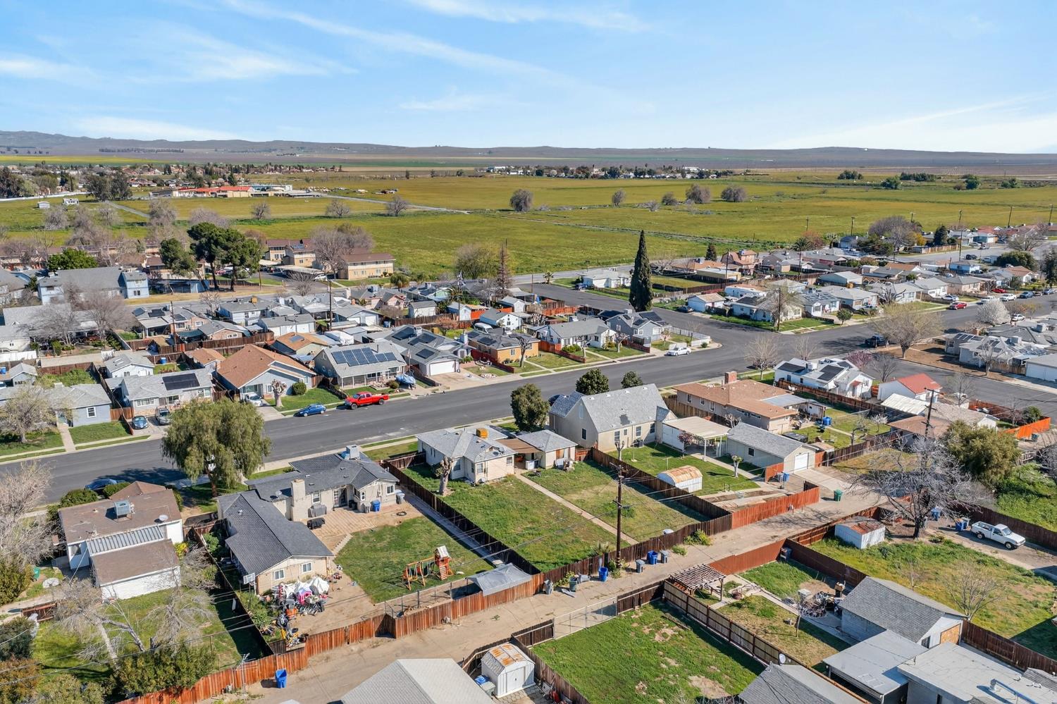 248 Harrison Street Coalinga, CA 93210 - Photo 12 of 30 an aerial view of a city with lots of residential buildings and ocean view in back