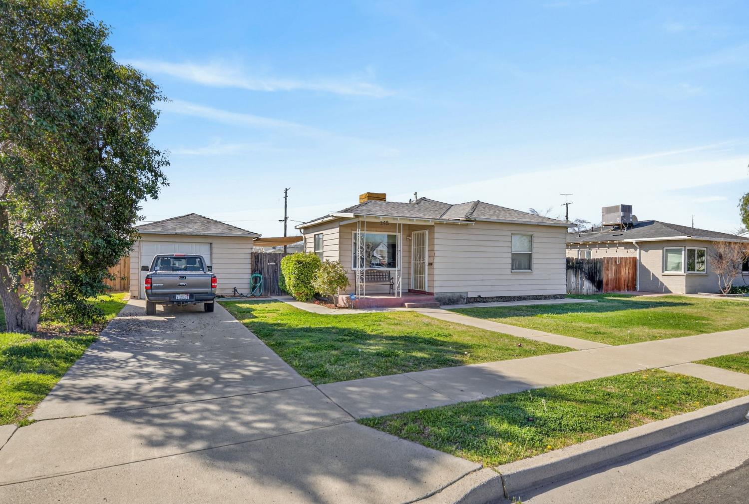 248 Harrison Street Coalinga, CA 93210 - Photo 22 of 30 a front view of a house with a yard and garage