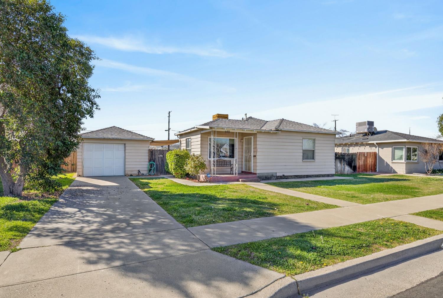 248 Harrison Street Coalinga, CA 93210 - Photo 4 of 30 a front view of a house with a yard and garage