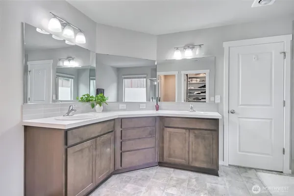a spacious bathroom with a granite countertop sink and a mirror