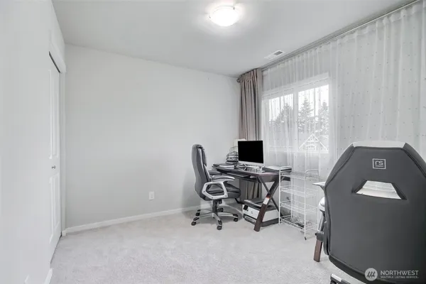 a work room with furniture and a window