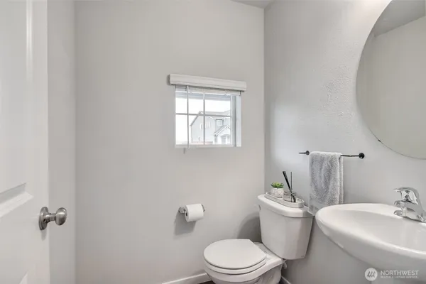 a white toilet sitting next to a bathroom sink