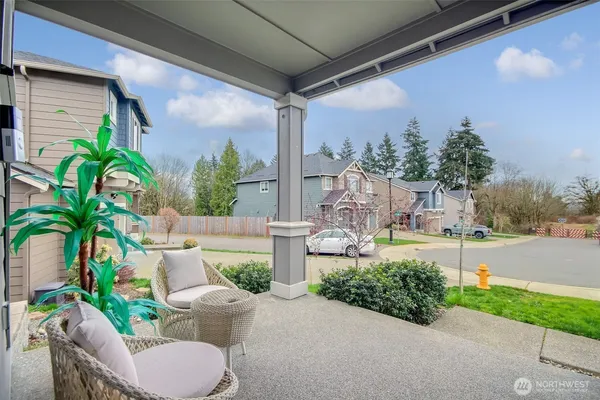a view of a porch with furniture and a yard