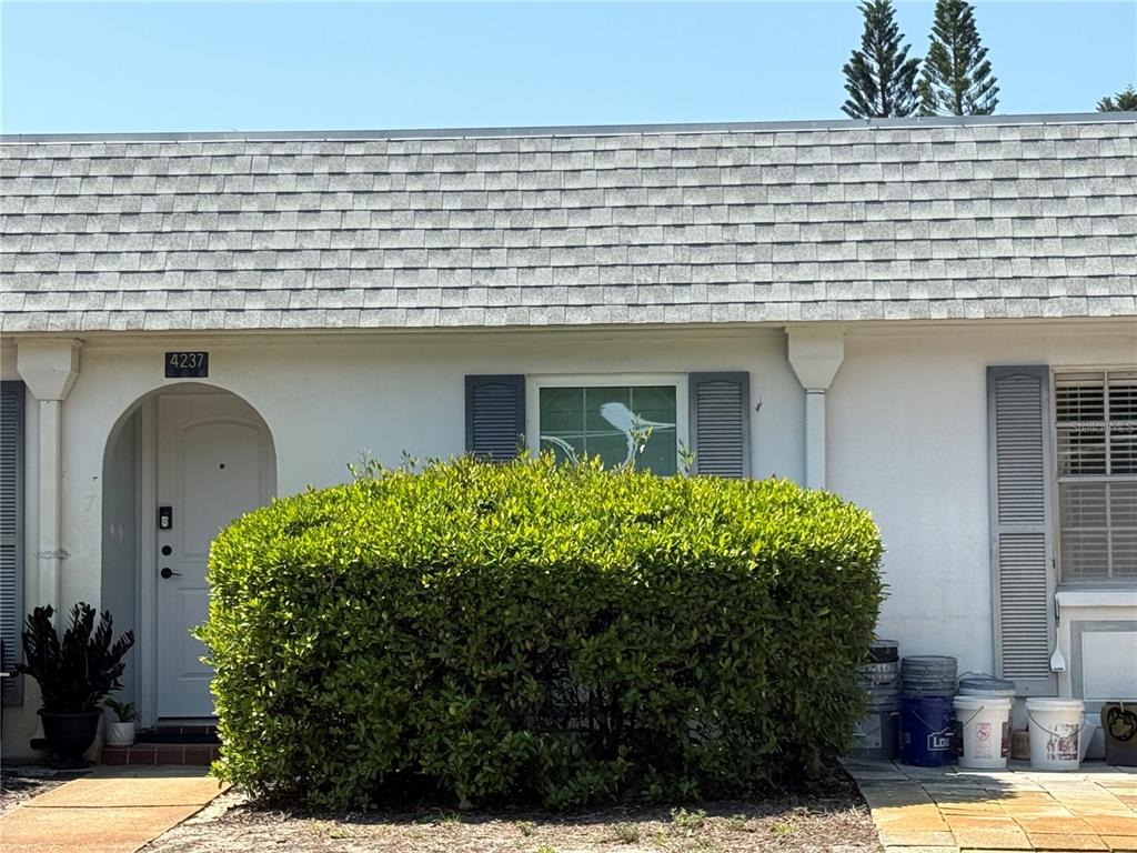4244 Sheldon Place, Unit 4244 New Port Richey, FL 34652 - Photo 1 of 23 a front view of a house with garden