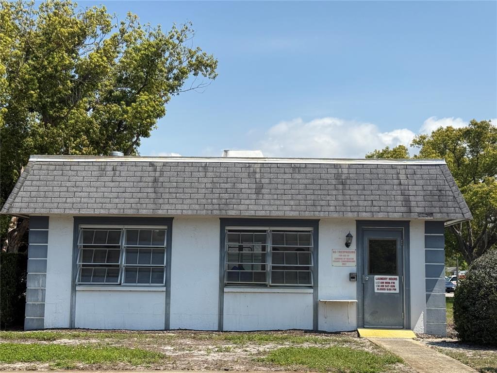4244 Sheldon Place, Unit 4244 New Port Richey, FL 34652 - Photo 21 of 23 a view of a house with potted plants and large tree