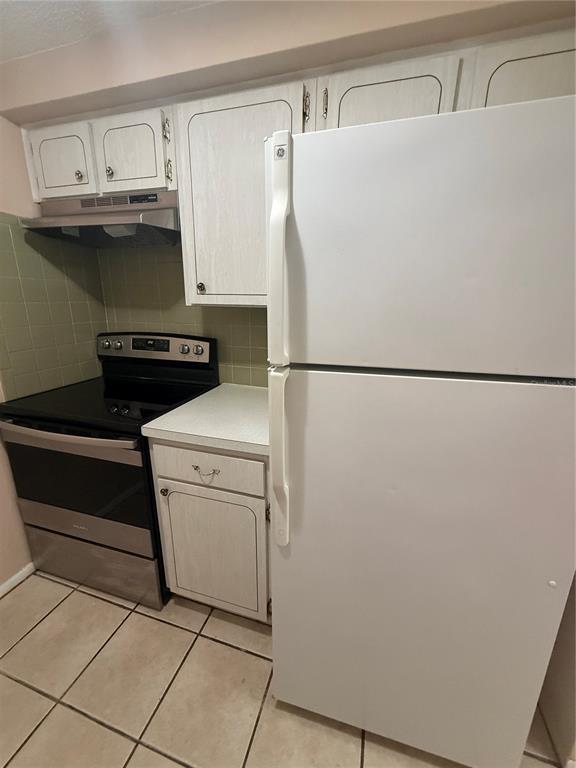 4244 Sheldon Place, Unit 4244 New Port Richey, FL 34652 - Photo 5 of 23 a white refrigerator freezer and a stove sitting inside of a kitchen