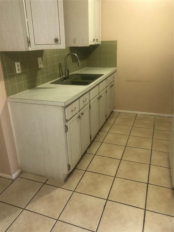 4244 Sheldon Place, Unit 4244 New Port Richey, FL 34652 - Photo 6 of 23 a kitchen with a sink and cabinets