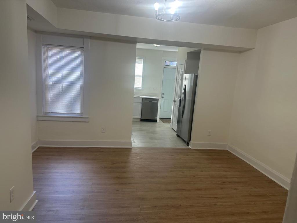 1220 North Potomac Street Baltimore, MD 21213 - Photo 4 of 34 DR view towards Kitchen w/ new laminate flooring