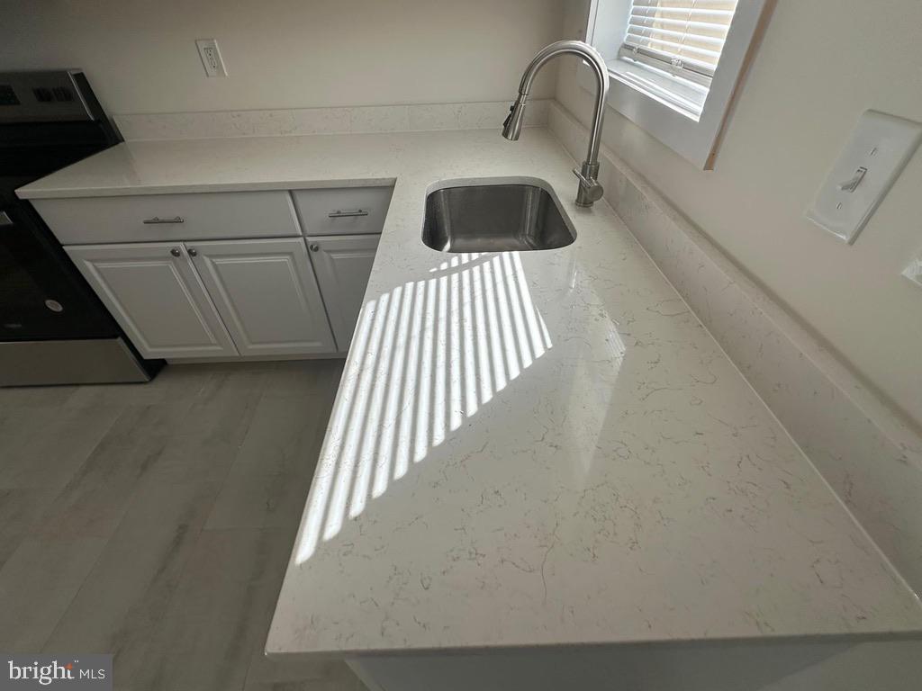 1220 North Potomac Street Baltimore, MD 21213 - Photo 7 of 34 View of nice updated quartz countertop & sink