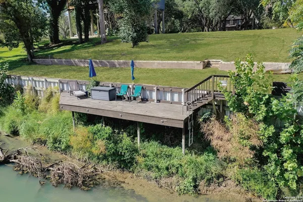 a view of a wooden deck with a yard