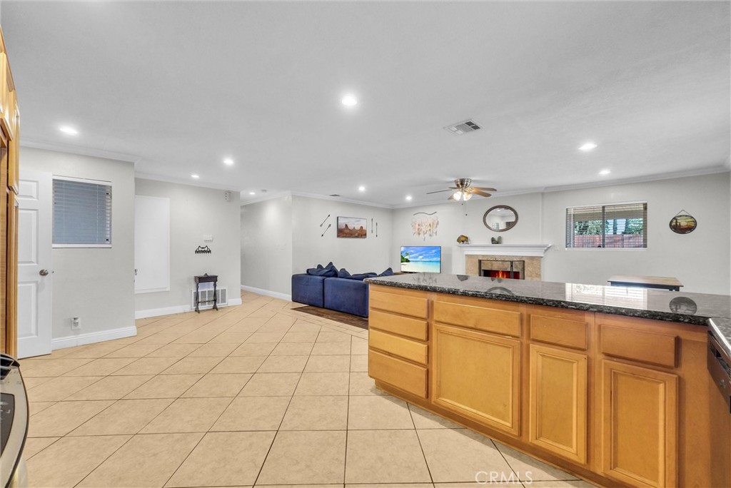 6220 Filkins Avenue Rancho Cucamonga, CA 91737 - Photo 18 of 37 a large white room with stainless steel appliances kitchen island granite countertop a sink and cabinets