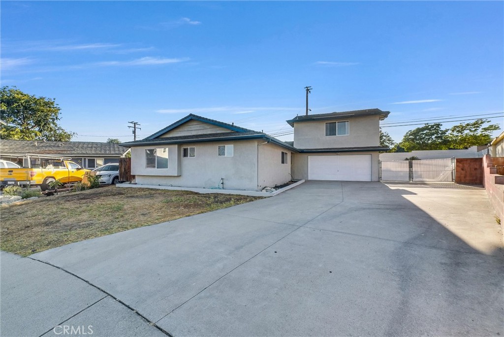 6220 Filkins Avenue Rancho Cucamonga, CA 91737 - Photo 2 of 37 a front view of a house with a yard and garage