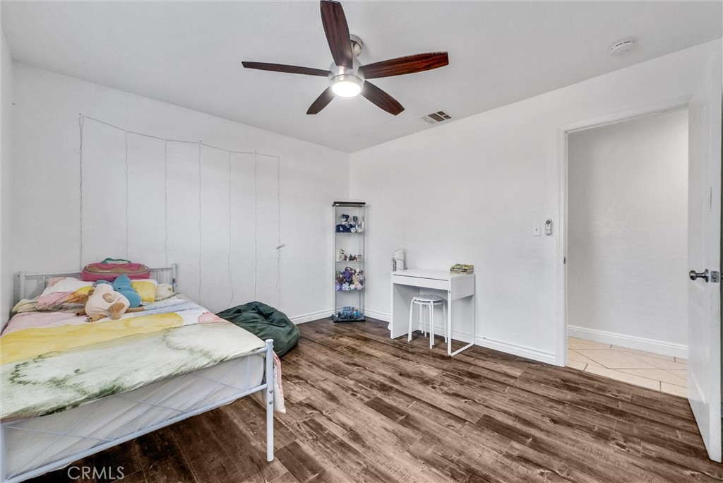 6220 Filkins Avenue Rancho Cucamonga, CA 91737 - Photo 21 of 37 a bedroom with a bed and a table in it