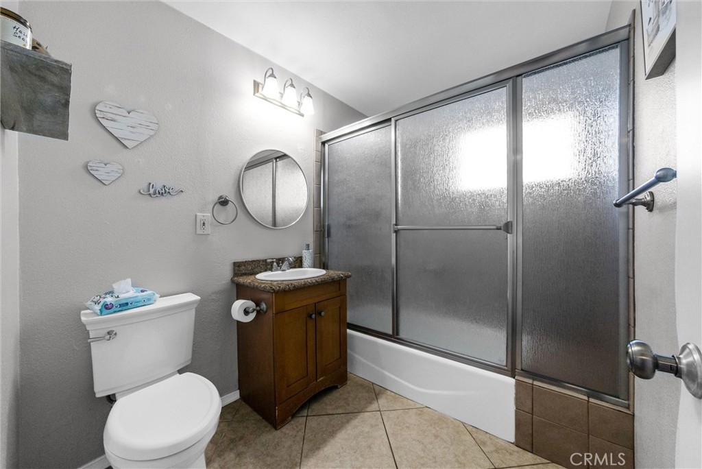 6220 Filkins Avenue Rancho Cucamonga, CA 91737 - Photo 24 of 37 a white toilet sitting next to a bathroom sink