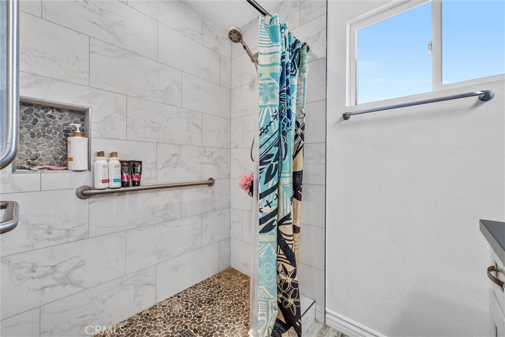 6220 Filkins Avenue Rancho Cucamonga, CA 91737 - Photo 27 of 37 a bathroom with a shower and a sink