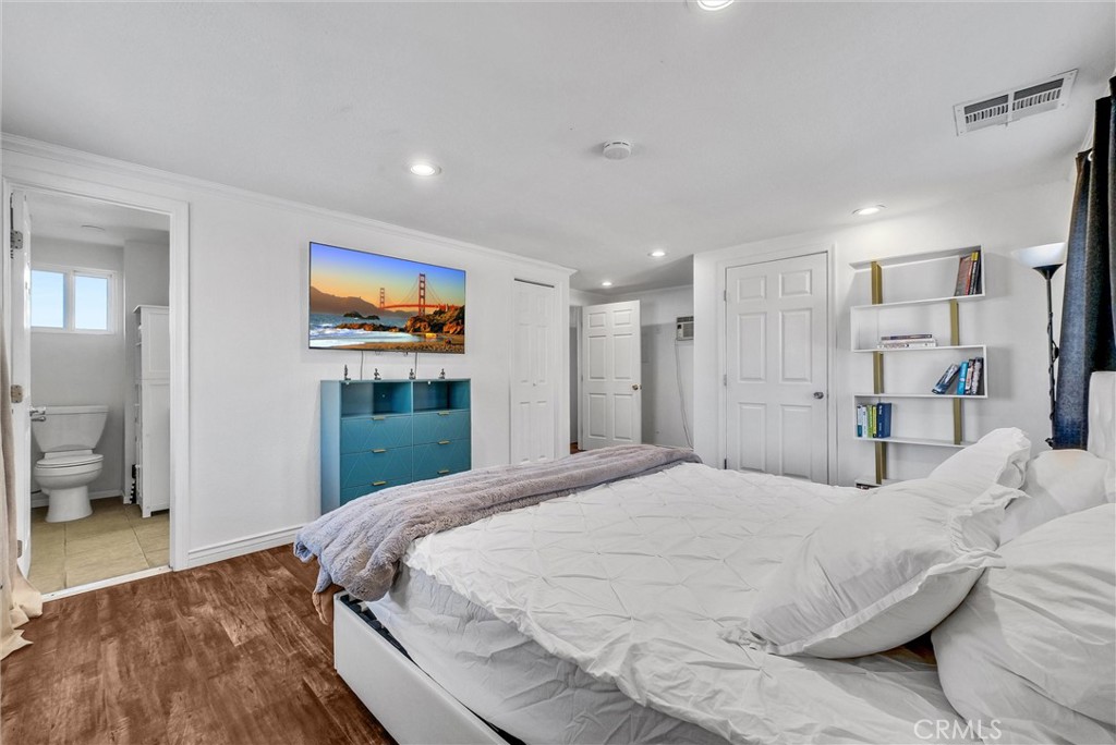 6220 Filkins Avenue Rancho Cucamonga, CA 91737 - Photo 31 of 37 a bedroom with a large bed and a large mirror