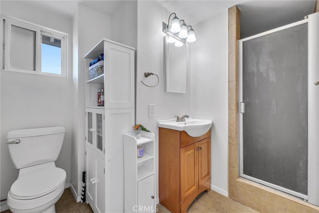 6220 Filkins Avenue Rancho Cucamonga, CA 91737 - Photo 32 of 37 a bathroom with a sink a toilet and shower