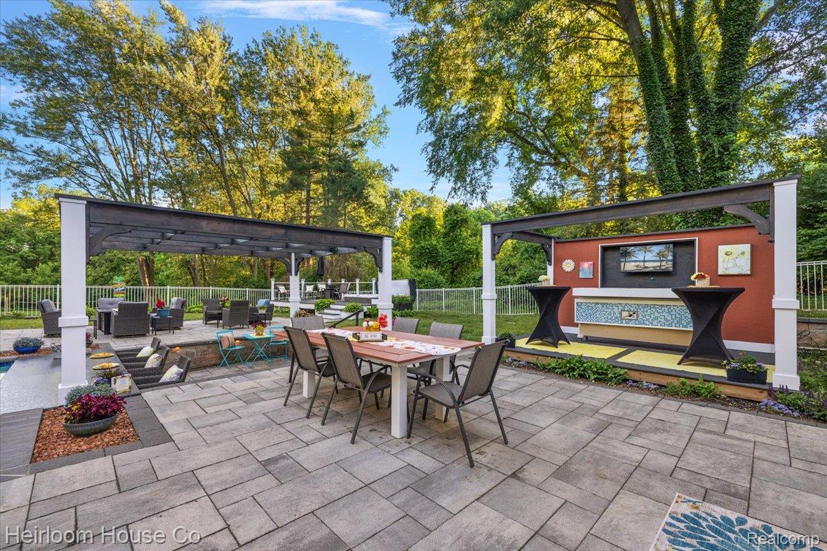 49001 Hanford Road Canton, MI 48187 - Photo 87 of 98 Expansive paver patio with a dining area and a separate covered lounge area featuring a fireplace