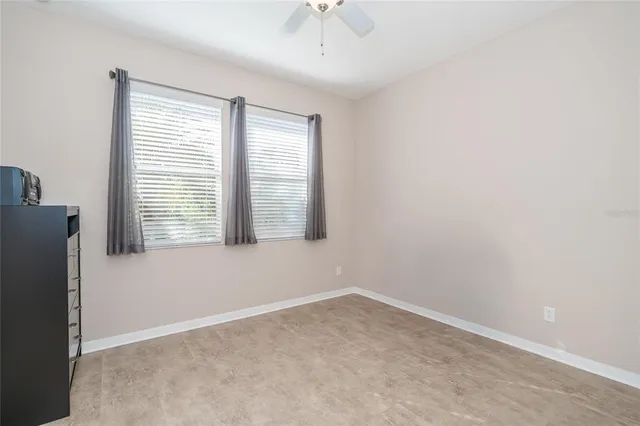 a living room filled with furniture and a large window