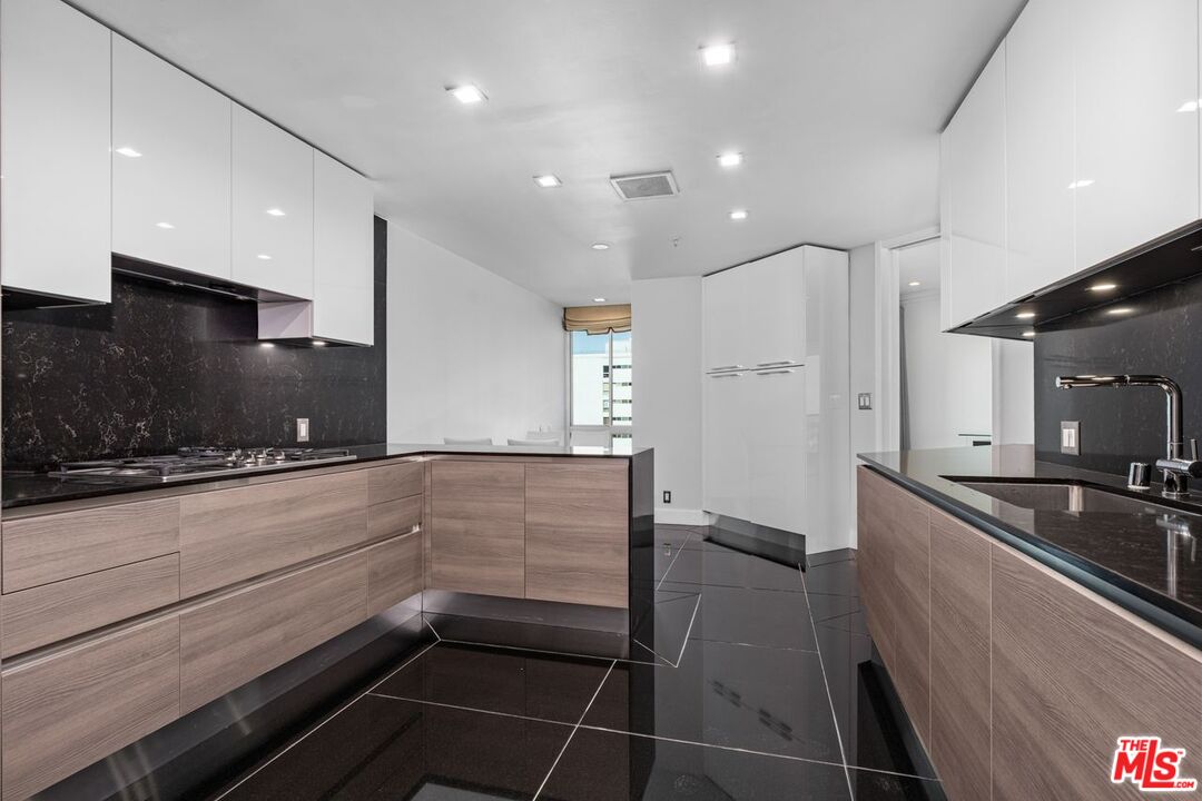 10490 Wilshire Boulevard, Unit 1004 Los Angeles, CA 90024 - Photo 17 of 45 a kitchen with stainless steel appliances a refrigerator and a sink