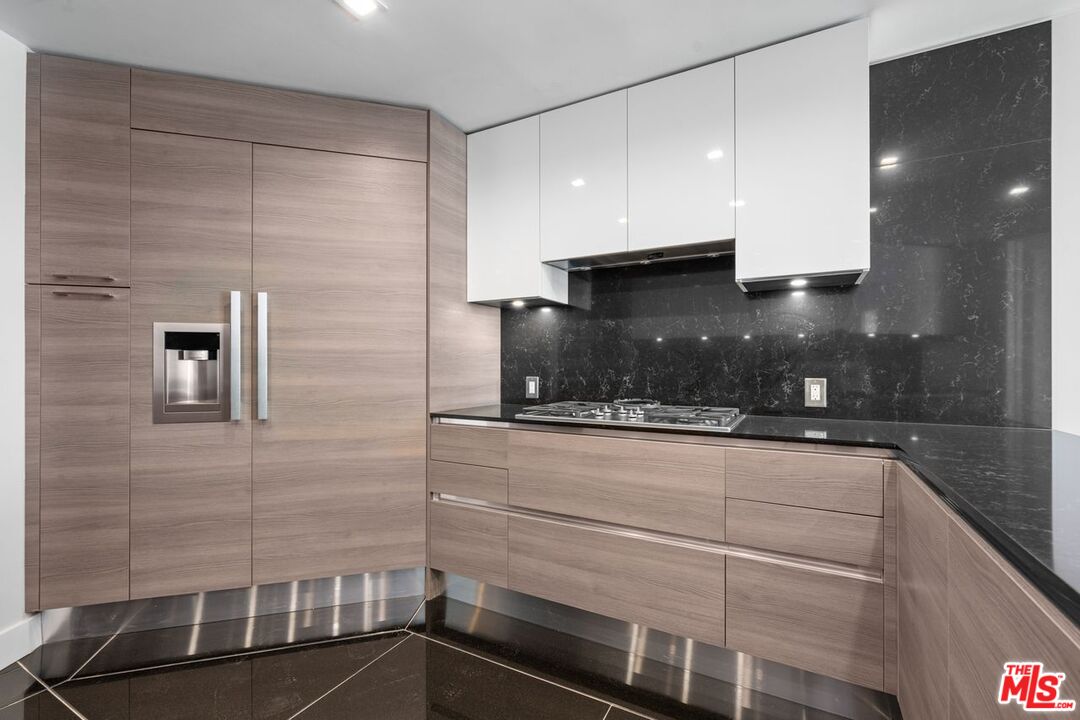 10490 Wilshire Boulevard, Unit 1004 Los Angeles, CA 90024 - Photo 19 of 45 a kitchen with a sink and cabinets