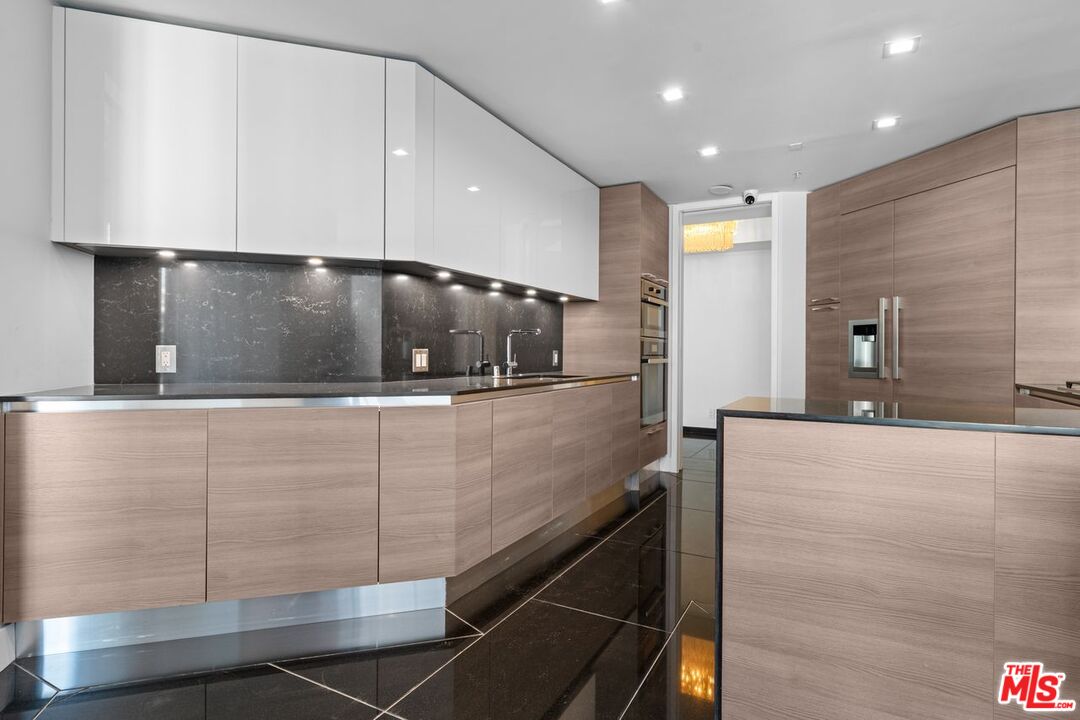 10490 Wilshire Boulevard, Unit 1004 Los Angeles, CA 90024 - Photo 21 of 45 a view of a large kitchen with a sink and an oven