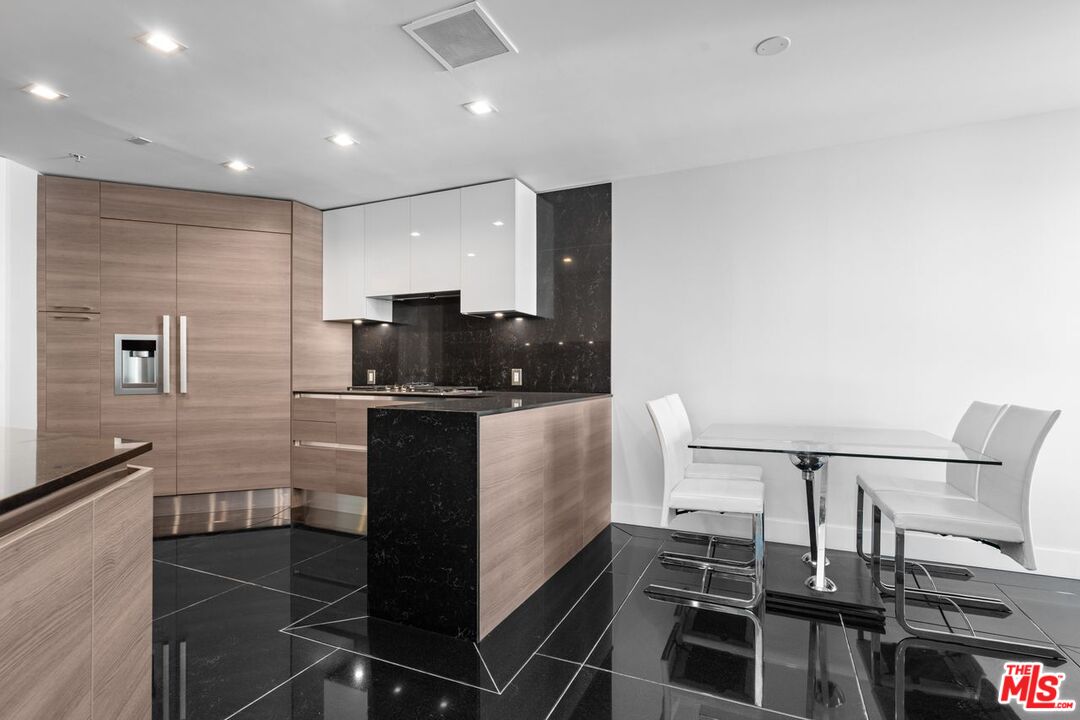 10490 Wilshire Boulevard, Unit 1004 Los Angeles, CA 90024 - Photo 22 of 45 a kitchen with a sink and counter top space