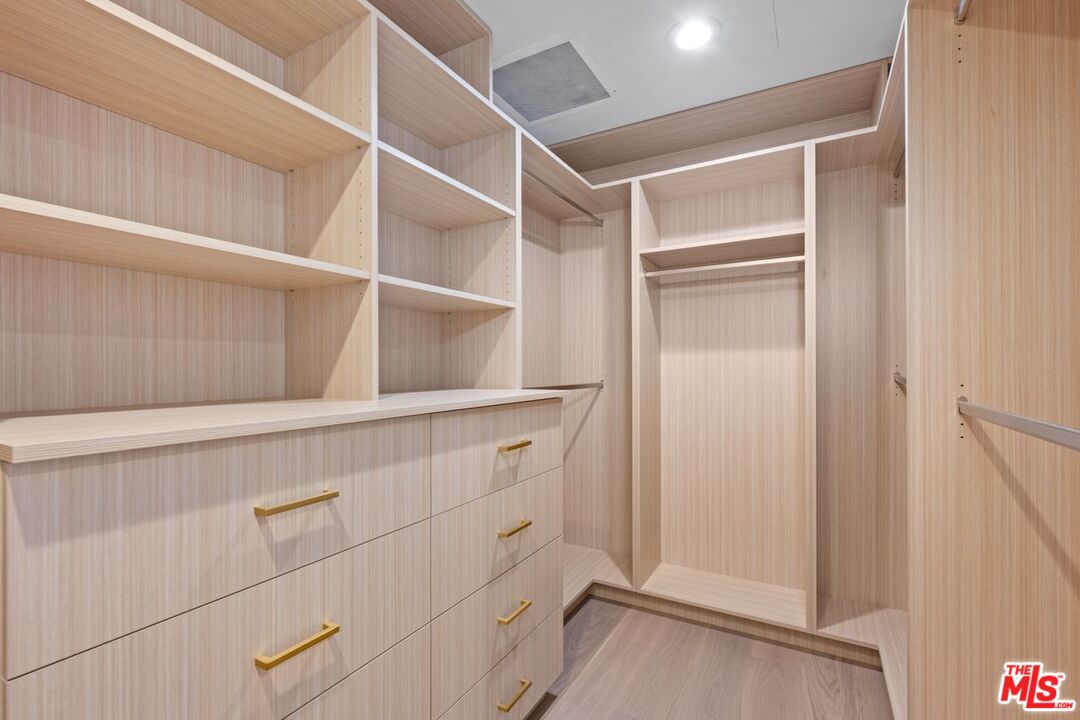 10490 Wilshire Boulevard, Unit 1004 Los Angeles, CA 90024 - Photo 30 of 45 a view of walk in closet with empty racks