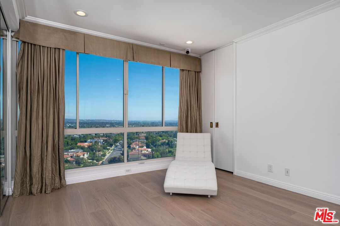 10490 Wilshire Boulevard, Unit 1004 Los Angeles, CA 90024 - Photo 35 of 45 a view of an empty room with wooden floor and a window